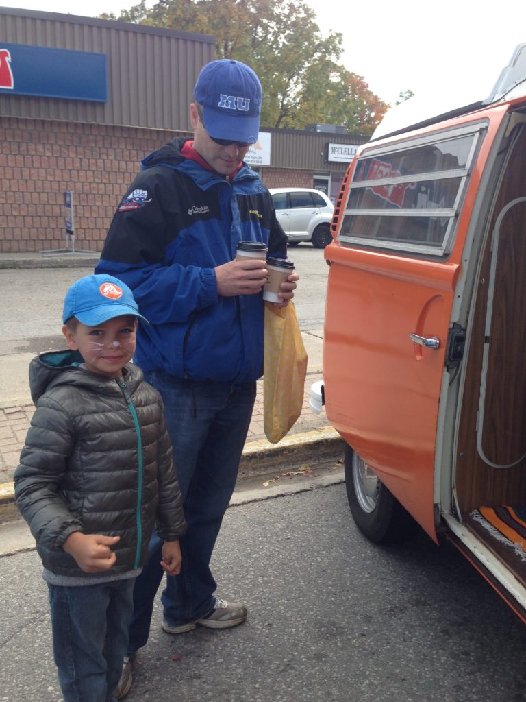 Father and son beside a Volkswagen Bus at Pumpkinfest