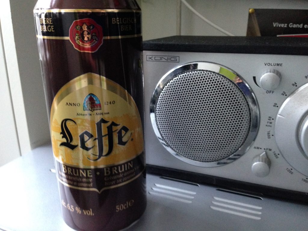 Leffe Brune Belgian Beer can next to a portable stereo