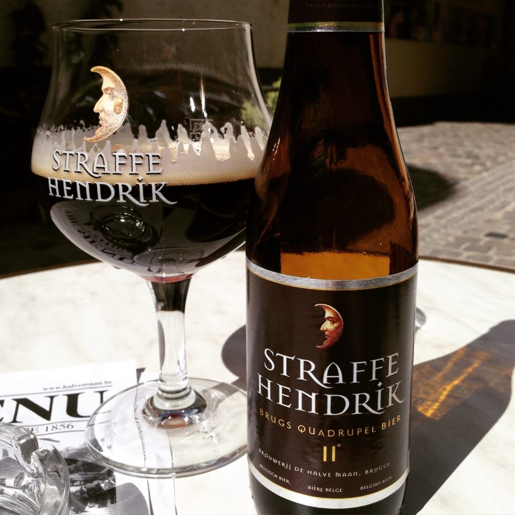Glass and bottle of Straffe Hendrik Quadrupel Belgian Beer on a table