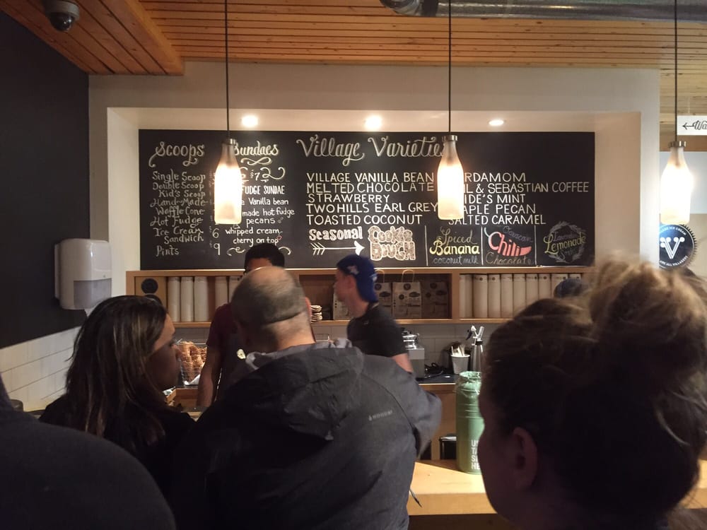 Village Ice Cream in Calgary menu with people standing in line behind the counter
