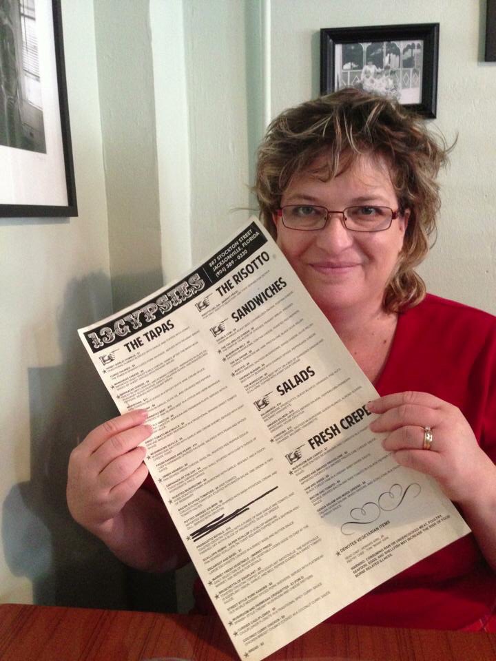 woman holding 13 Gypsies Menu