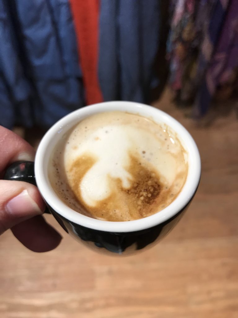 holding a maple macchiato espresso coffee