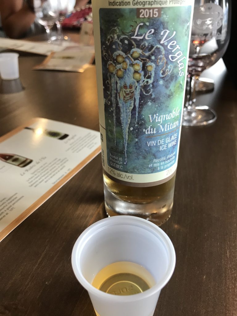 small cup of ice wine for sampling and ice wine bottle 