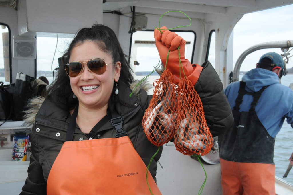 smiling woman holding bait bags