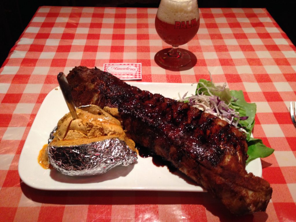 rib dinner deal in Ghent - a rack of ribs with baked potato and coleslaw with a Belgian beer