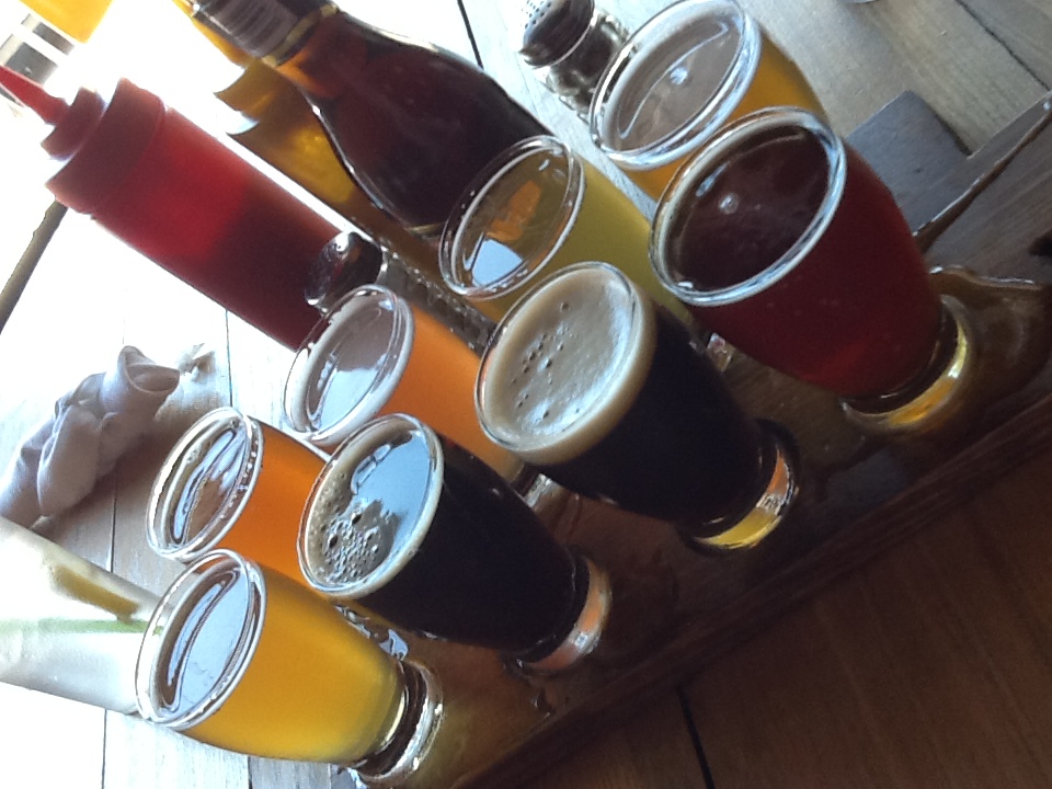 craft beer with good food - a flight of beer, 8 glasses on a tray