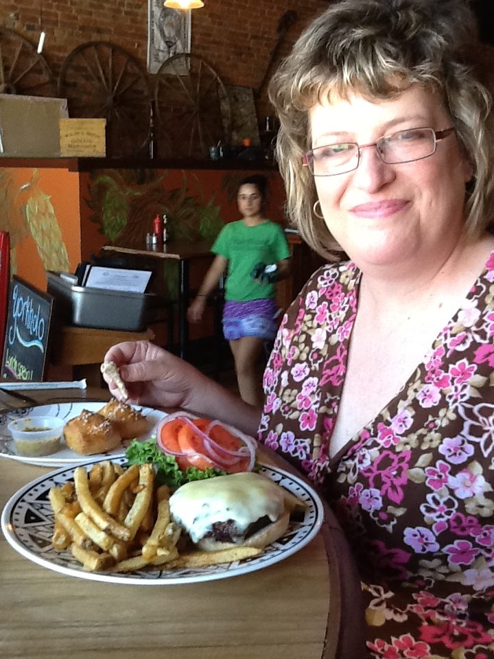 woman poses with burger
