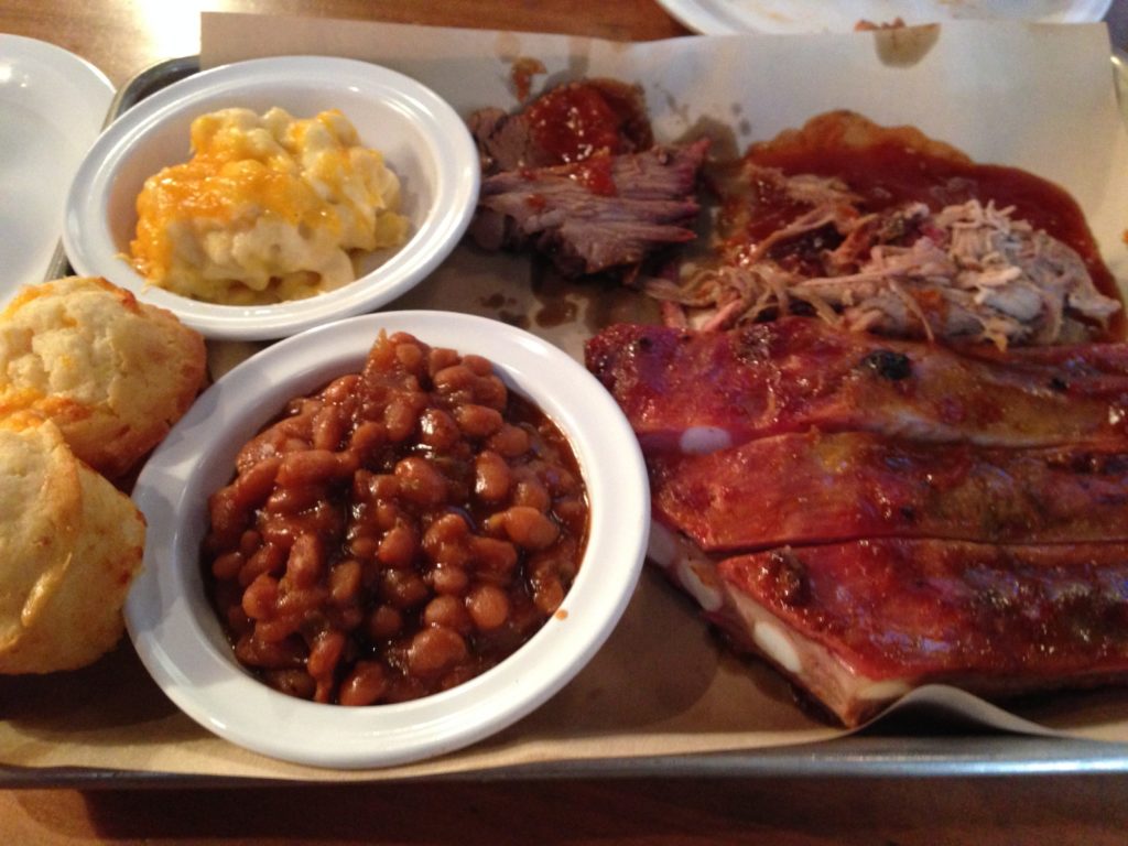 Great BBQ in Charleston, like this platter of brisket and ribs with beans, mac n cheese and cheddar biscuits.