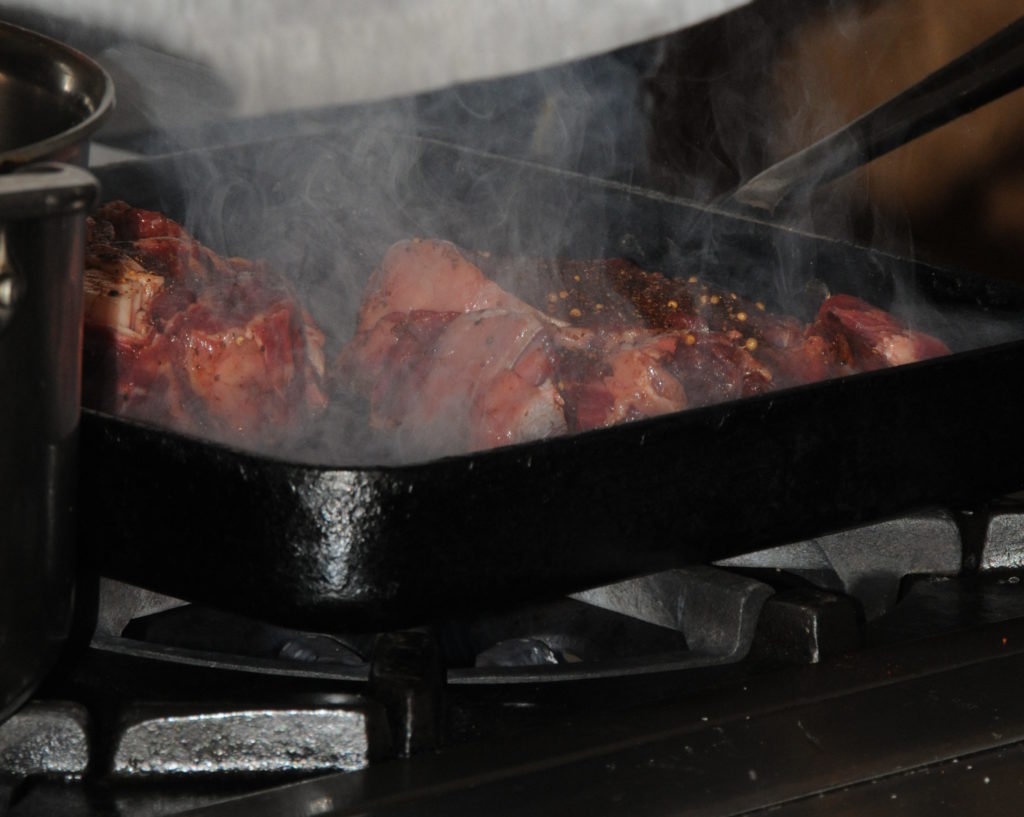 sizzling steak in a pan