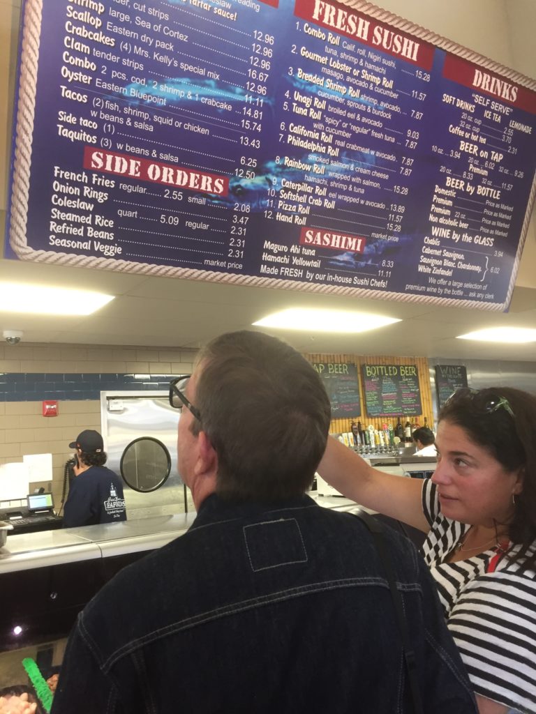 two people looking at an overhead menu