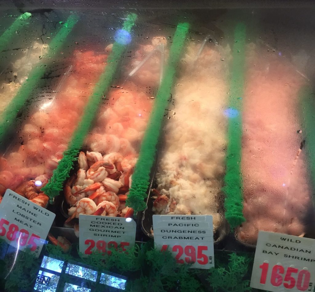 shrimp displayed in a foggy glass counter at Point Loma Seafoods