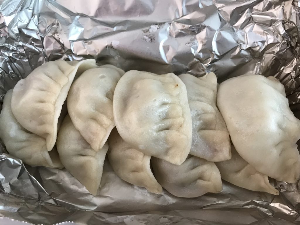 beef momo dumplings wrapped in aluminum foil at Loga's Corner in Toronto