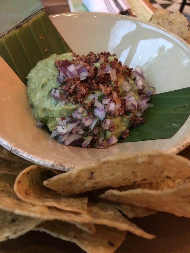 tortilla chips and guacamole with bacon and onion at Frontera Cocina