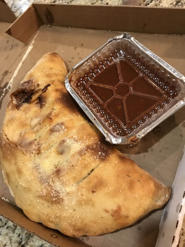 calzone with side of sauce.
