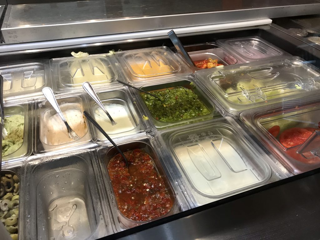 variety of toppings in containers at South St Burger in Ajax
