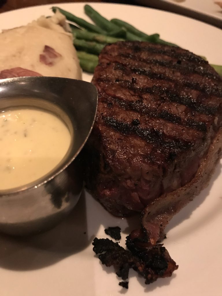 bacon-wrapped filet mignon, garlic mashed potatoes, green vegetable and hollandaise sauce at The Keg in Ajax