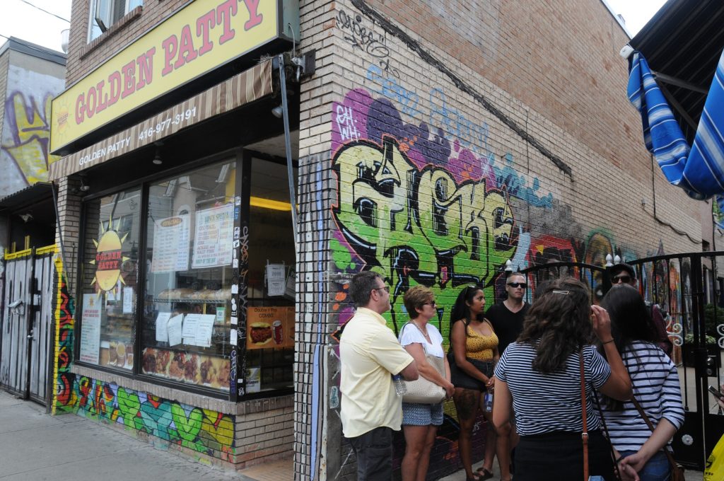 Exterior Golden Patty in Kensington Market with food tour group gathered outside