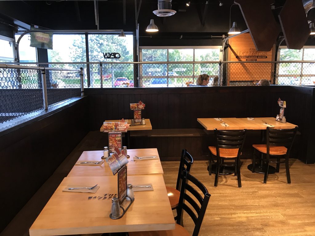 Interior of The Works Gourmet Burger Bistro in Pickering with booths and tables