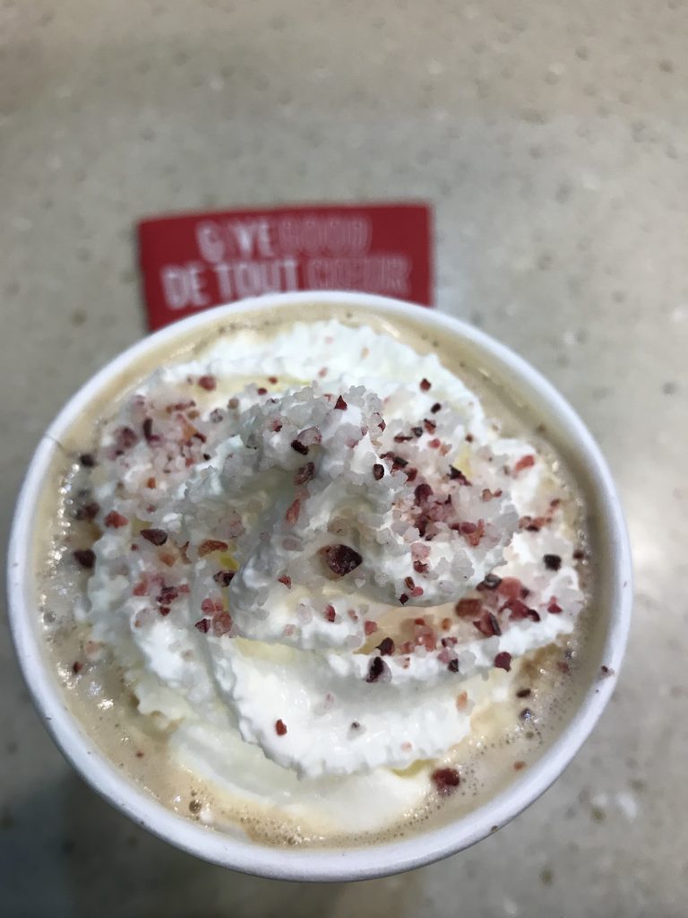 Seasonal specialty coffee with whipped cream and sugar sprinkles at Starbucks