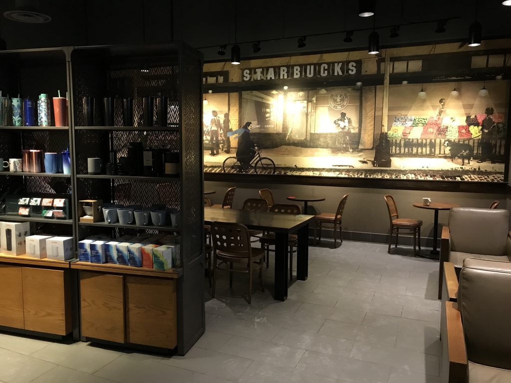 interior with tables and merchandise at Starbucks in Pickering